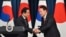 South Korean President Yoon Suk Yeol, right, shakes hands with Japanese Prime Minister Fumio Kishida during a joint press conference after their meeting at the presidential office in Seoul, May 7, 2023.