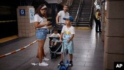 FILE - Migrant Darwin Salinas travels with wife Kimberly Carchipulla and sons Damien, 6, and Derek, 1, June 16, 2024, Jersey City, NJ.