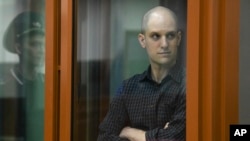 FILE - Wall Street Journal reporter Evan Gershkovich stands in a glass cage in a courtroom in Yekaterinburg, Russia, June 26, 2024.