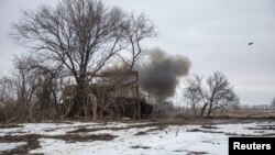 Ukrainian servicemen of the 28th Independent Mechanized Brigade fire 2S3 Akatsiya self-propelled howitzer towards Russian positions, near the frontline town of Bakhmut, as Russia's attack on Ukraine continues, Donetsk region, Feb. 25, 2023. 