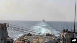 FILE — In this image provided by the U.S. Navy, the amphibious dock landing ship USS Carter Hall and amphibious assault ship USS Bataan transit the Bab al-Mandeb strait, Aug. 9, 2023. 