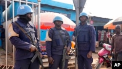 FILE - United Nations peacekeepers stand in the market in Bouar, Central African Republic, March 8, 2024. Nearly 5,000 fighters have put down their arms in Central African Republic since a disarmament program launched nearly a decade ago. 