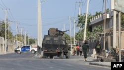 FILE - Security forces patrol outside a building that was attacked by suspected al-Shabab militants in the Somalia's capital Mogadishu on Feb. 21, 2023.