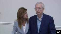 FILE - Robbin Taylor, an aide to U.S. Sen. Mitch McConnell, R-Ky., joins McConnell while he speaks at the Madison Event Center, Aug. 30, 2023, in Covington, Ky. McConnell appeared to briefly freeze up, weeks after he had a similar episode in Washington.