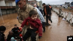 People are rescued during floods after heavy rains in Sanliurfa, Turkey, March 15, 2023. 