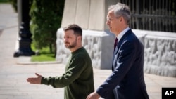 Ukrainian President Volodymyr Zelenskyy, left, walks with NATO Secretary General Jens Stoltenberg before their press conference in Kyiv, April 29, 2024.