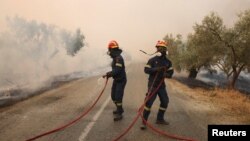Firefighters battle a wildfire raging in Alexandroupolis, in Greece's Evros region, Aug. 22, 2023.