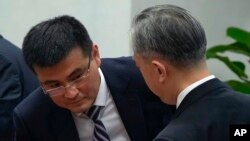 Deputy Director of Department of Eurasia of Ministry of Foreign Affairs Yu Jun, left, speaks with Chinese Foreign Ministry spokesperson Wang Wenbin after a news conference in Beijing, Wednesday, April 26, 2023. (AP Photo/Andy Wong)