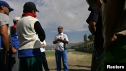 FILE - Afghan national cricket team coach, Taj Maluk, speaks to his team in Kabul, May 27, 2006.