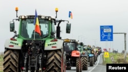 Romanian farmers line up their tractors en route to Nadlac Customs while protesting over the price of grains, in Remetea Mare, Timis county, Romania, April 7, 2023. (Inquam Photos/Cornel Putan via Reuters)