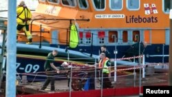 Rescuers assist a migrant who was brought ashore in Dover, Britain, after a boat carrying migrants from France sunk in the English Channel on Aug. 12, 2023. (Stuart Brock via Reuters)