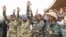 FILE - Nigerien military leaders wave to supporters at the General Seyni Kountche Stadium in Niamey, Niger, on Aug. 26, 2023. 
