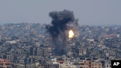 Smoke and fire rise from an explosion caused by an Israeli airstrike on Gaza City, May 10, 2023.