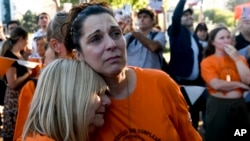 FILE - Sandra Miasnik, right, an aunt of Argentine-Israeli infant Kfir Bibas, a hostage of Hamas in Gaza, attends a gathering one day before his first birthday in Buenos Aires, Argentina, Jan. 17, 2024.