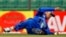 FILE - Afghanistan's Karim Sadiq dives to catch the ball while fielding during the Asia Cup one-day international cricket tournament against Pakistan in Fatullah, near Dhaka, Bangladesh, Feb. 27, 2014. 