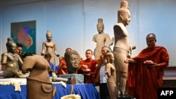 Buddhist monks take part in a repatriation ceremony for Angkorian artifacts returned from the United States at the National Museum in Phnom Penh, Cambodia, July 4, 2024. 