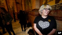 Ashley Blinkhorn of Boulder, Colo., talks after she and other supporters witnessed the signing of bills enshrining protections for abortion and gender-affirming care, April 14, 2023, in the State Capitol in Denver.
