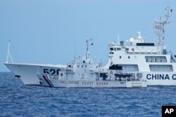A Chinese coast guard ship with bow number 5201 blocks Philippine coast guard ship BRP Malapascua as it maneuvers to enter the mouth of the Second Thomas Shoal, locally known as Ayungin Shoal, at the South China Sea, April 23, 2023.
