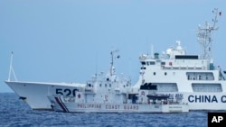 A Chinese coast guard ship with bow number 5201 blocks Philippine coast guard ship BRP Malapascua as it maneuvers to enter the mouth of the Second Thomas Shoal, locally known as Ayungin Shoal, at the South China Sea, April 23, 2023.