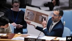 Jonah Leff of Conflict Armament Research shows pictures of debris from armaments used by Russia, found in Ukraine, during a Security Council meeting at U.N. headquarters, June 28, 2024. The findings indicate the weapons were made in North Korea.