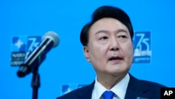 South Korea's President Yoon Suk Yeol speaks to reporters during his arrival at the NATO summit in Washington, July 11, 2024.