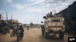 FILE - United Nations South African peacekeepers patrol a street in Oicha where an attack took place in a nearby village the day before, Jan. 29, 2020. 