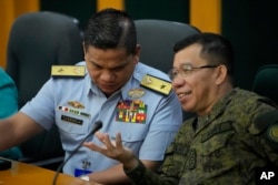 菲律宾海岸警卫队发言人杰伊·塔里拉准将 （左）和菲律宾武装部队发言人梅德尔·阿吉拉尔上校在有关该国船只被中国船只撞击事件的记者会上。（2023年10月23日）