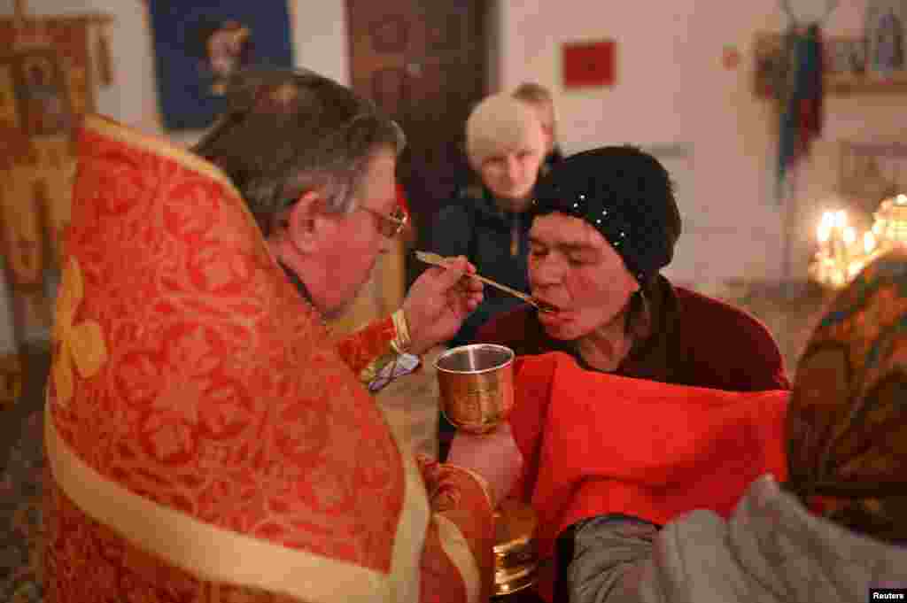 A priest conducts a ceremony during the Orthodox Easter service at the Church of the Saviour's Transfiguration in the village of Lozhnikovo in the Omsk region, Russia, May 4, 2024. 