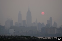 The sun rises over a hazy New York City skyline as seen from Jersey City, N.J., Wednesday, June 7, 2023. Intense Canadian wildfires are blanketing the northeastern U.S. in a dystopian haze, turning the air acrid, the sky yellowish gray and prompting warnings for vulnerable populations to stay inside.