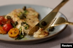 FILE - A cooked piece of cultivated chicken breast is seen, which was created at the Upside Foods plant, in Emeryville, California, Jan. 11, 2023.