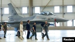 FILE - Ukrainian President Volodymyr Zelenskyy and Dutch Prime Minister Mark Rutte walk past an F-16 fighter jet in Eindhoven, Netherlands, Aug. 20, 2023.