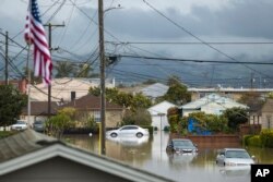 Cars sit partially submerged in floodwaters in Watsonville, California, March 11, 2023.