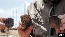 Photo released by Peruvian Ministry of Culture on August 27, 2023 shows pottery pieces found at a 3,000-year-old priest's tomb, at the Pacopampa archeological site, in Cajamarca, Peru.
