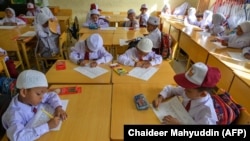 Para siswa mengikuti hari pertama sekolah di sebuah sekolah dasar di Banda Aceh pada 17 Juli 2023 (Foto: AFP)