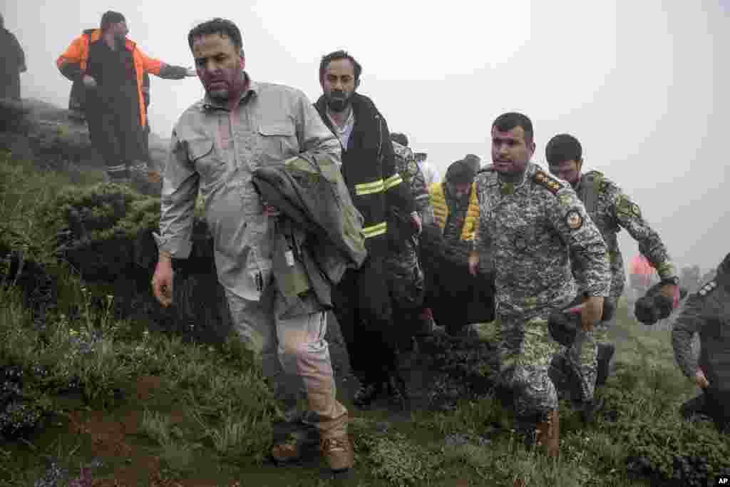 In this photo provided by Moj News Agency, rescue team members carry the body of a victim after a helicopter carrying Iranian President Ebrahim Raisi crashed in Varzaghan in northwestern Iran, May 20, 2024.&nbsp;