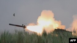 FILE - An M142 High Mobility Artillery Rocket System (HIMARS) fires during Phillipine-U.S. exercises at Capas, Philippines, Oct. 13, 2022. The U.S. on March 21, 2023, said it would send more military aid to Ukraine, including HIMARS ammunition.