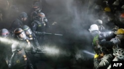 Cops face-off with pro-Palestinian students after destroying part of the encampment barricade on the campus of the University of California, Los Angeles (UCLA) in Los Angeles, California, May 2, 2024.