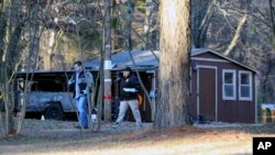 Law enforcement personnel investigate one of the scenes of multiple shootings in Arkabutla, Mississippi, on Feb. 17, 2023.