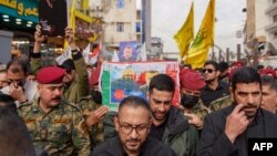 Honor guards carry the coffin of Razi Moussavi during his funeral procession at the Imam Ali shrine in Iraq's holy city of Najaf, on Dec. 27, 2023.