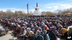 People from Ladakh participate in a sit-in protest demanding constitutional safeguards for their mountainous region in Leh, India, March 24, 2024.