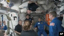 In this image from NASA TV, the four astronauts including United Arab Emirates' Sultan al-Neyadi, centre right, enter the pad of the International Space Station, March 3, 2023.