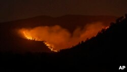 FILE - The Hermits Peak-Calf Canyon Fire burns south of Las Vegas, New Mexico, May 7, 2022. 