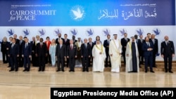 Participants of the Cairo Summit for Peace for a photo just outside Cairo, Oct. 21, 2023. (Egyptian Presidency Media Office via AP)