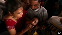 FILE - An asthma patient is administered a traditional fish medicine in Hyderabad, India, June 9, 2023.
