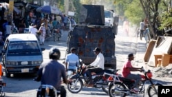 An armored police car patrols the streets in Port-au-Prince, Haiti, Jan. 26, 2024. Haiti's government on Jan. 29 announced a crackdown on a state environmental department whose heavily armed agents were blamed for violent clashes with police last week. 