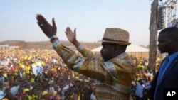 Zimbabwe's main opposition leader Nelson Chamisa is surrounded by security as he leaves a campaign rally in Harare on Aug. 21, 2023.