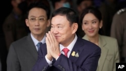 Mantan Perdana Menteri Thailand Thaksin Shinawatra, tengah, bersama putranya Phantongtae dan putrinya Pinthongta, tiba di Bandara Don Muang di Bangkok, Thailand, 22 Agustus 2023. (Foto: AP)