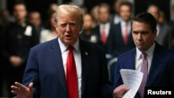 FILE - Then-presidential candidate Donald Trump speaks to reporters upon arrival at his trial for allegedly covering up hush money payments, at Manhattan Criminal Court in New York City, May 16, 2024. 