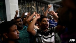 Supporters of Islamist leader Delwar Hossain Sayeedi chant slogans as they gather in front of a hospital, where he died following a heart attack, in Dhaka, Bangladesh, on Aug. 14, 2023. 