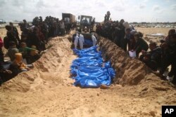 Palestinians attend a mass funeral of people killed in the Israeli offensive on Khan Younis in Rafah, Gaza Strip, March 7, 2024.